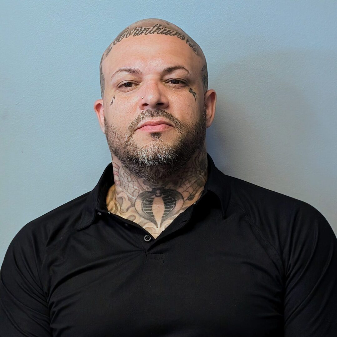 A man with tattoos on his face and neck.