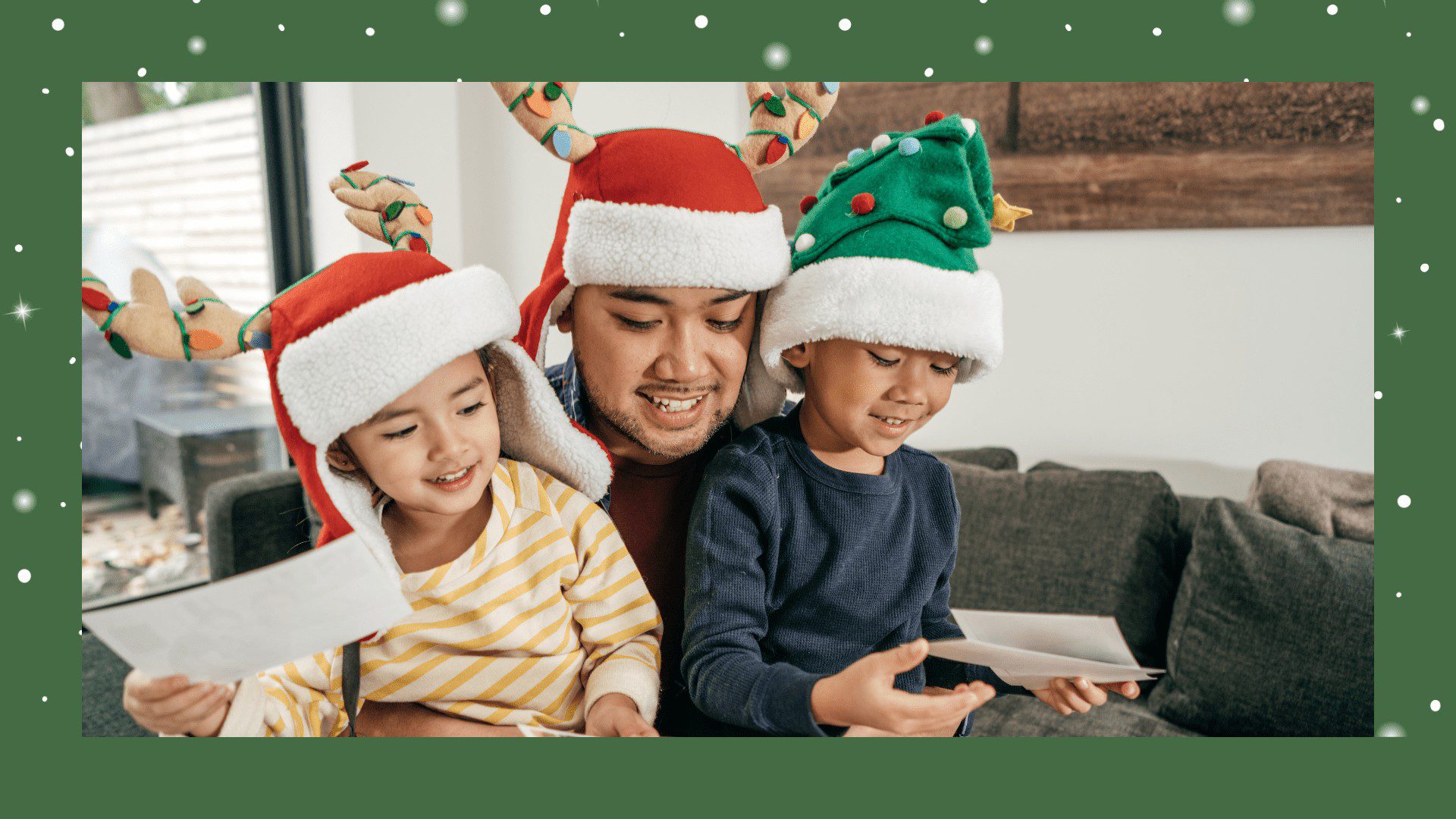 A man and two children wearing christmas hats.