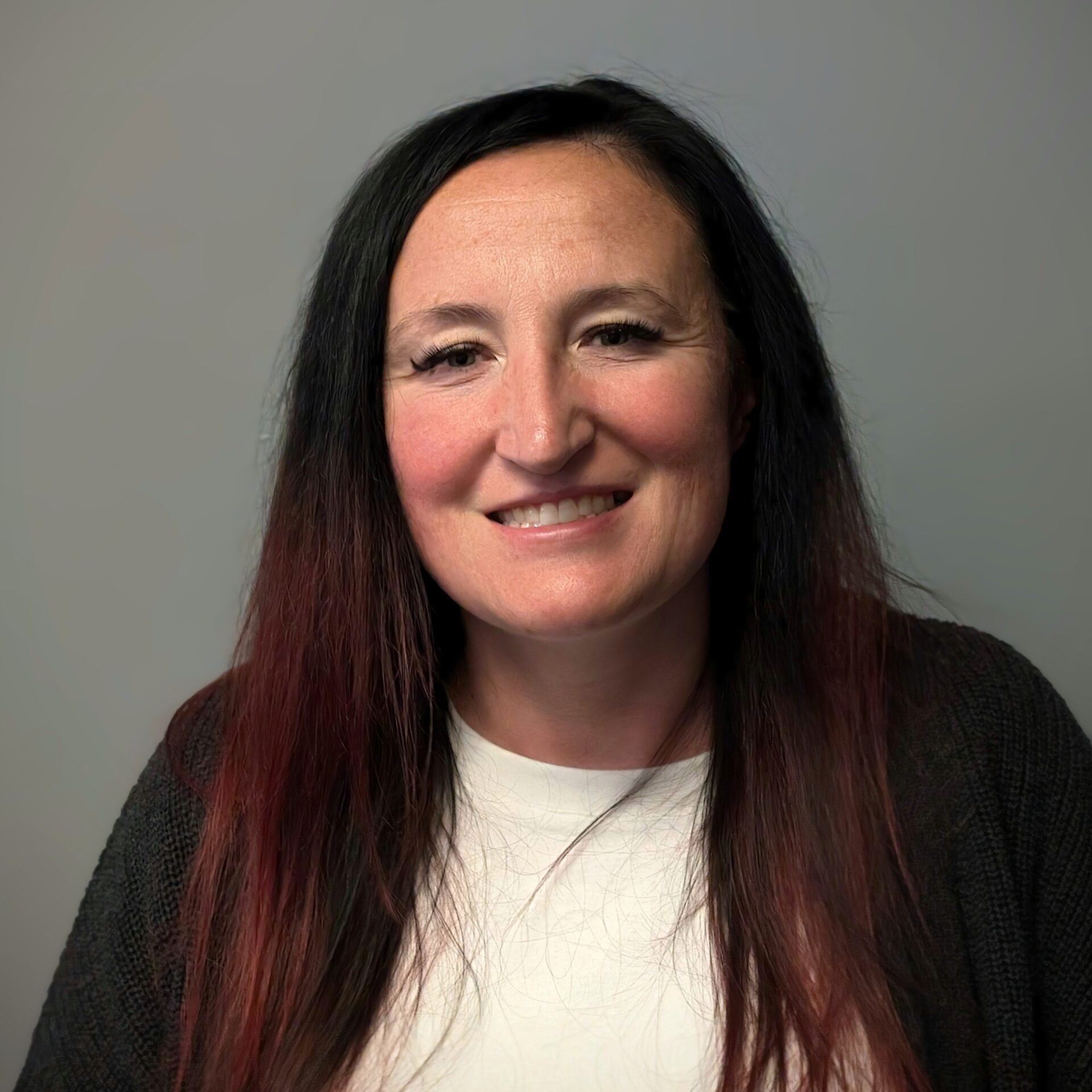 Headshot of a woman with long brown hair.